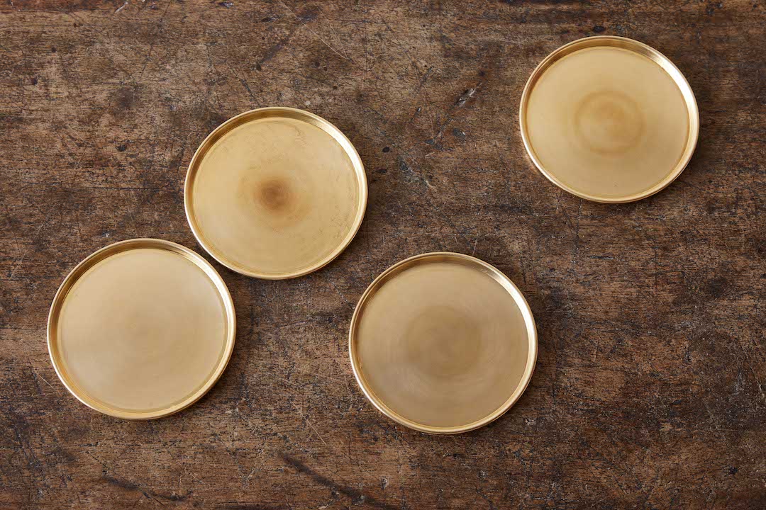 A pair of brass vintage clamshell wine coasters — ROCOCO