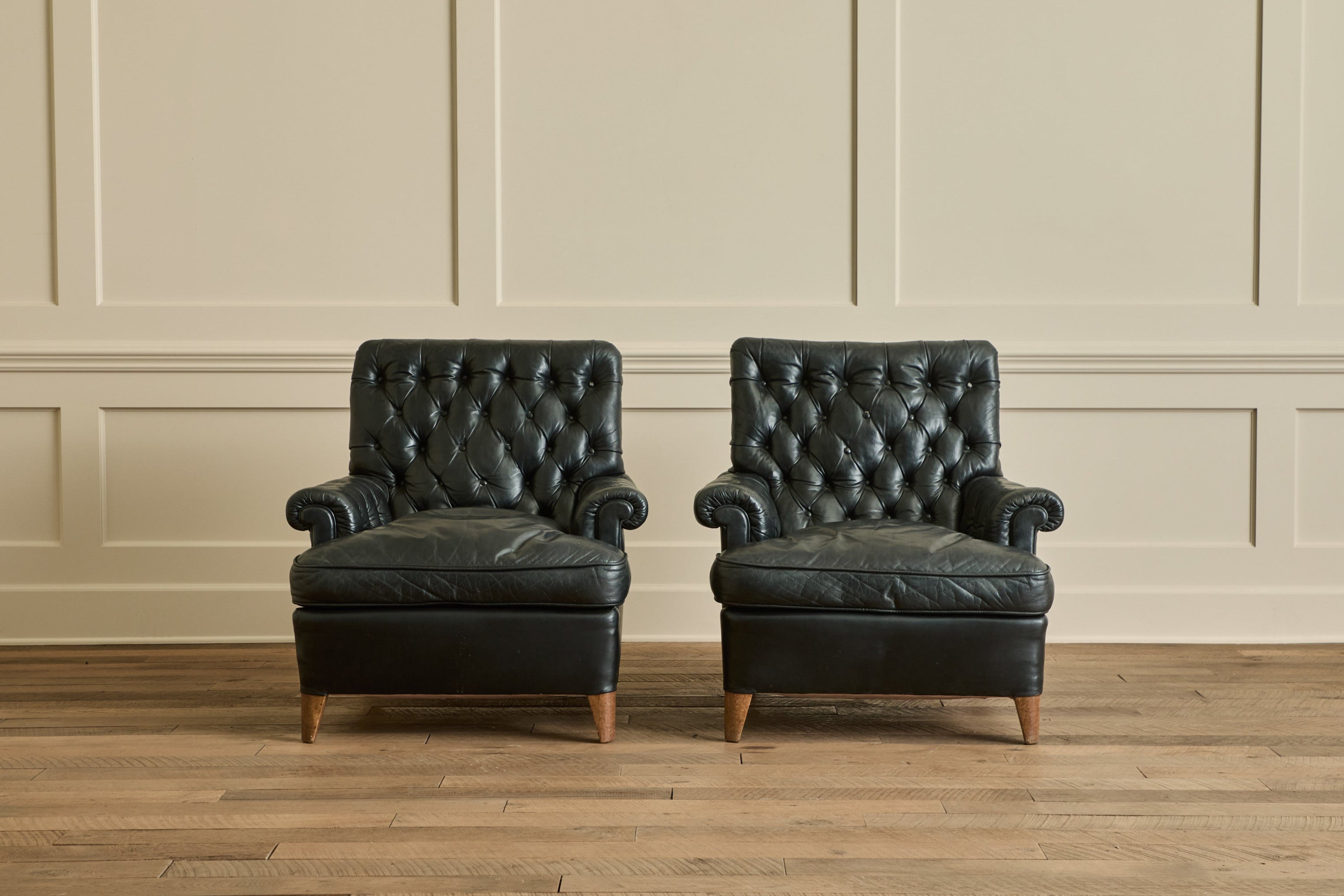 Pair of Tufted Black Leather Chairs