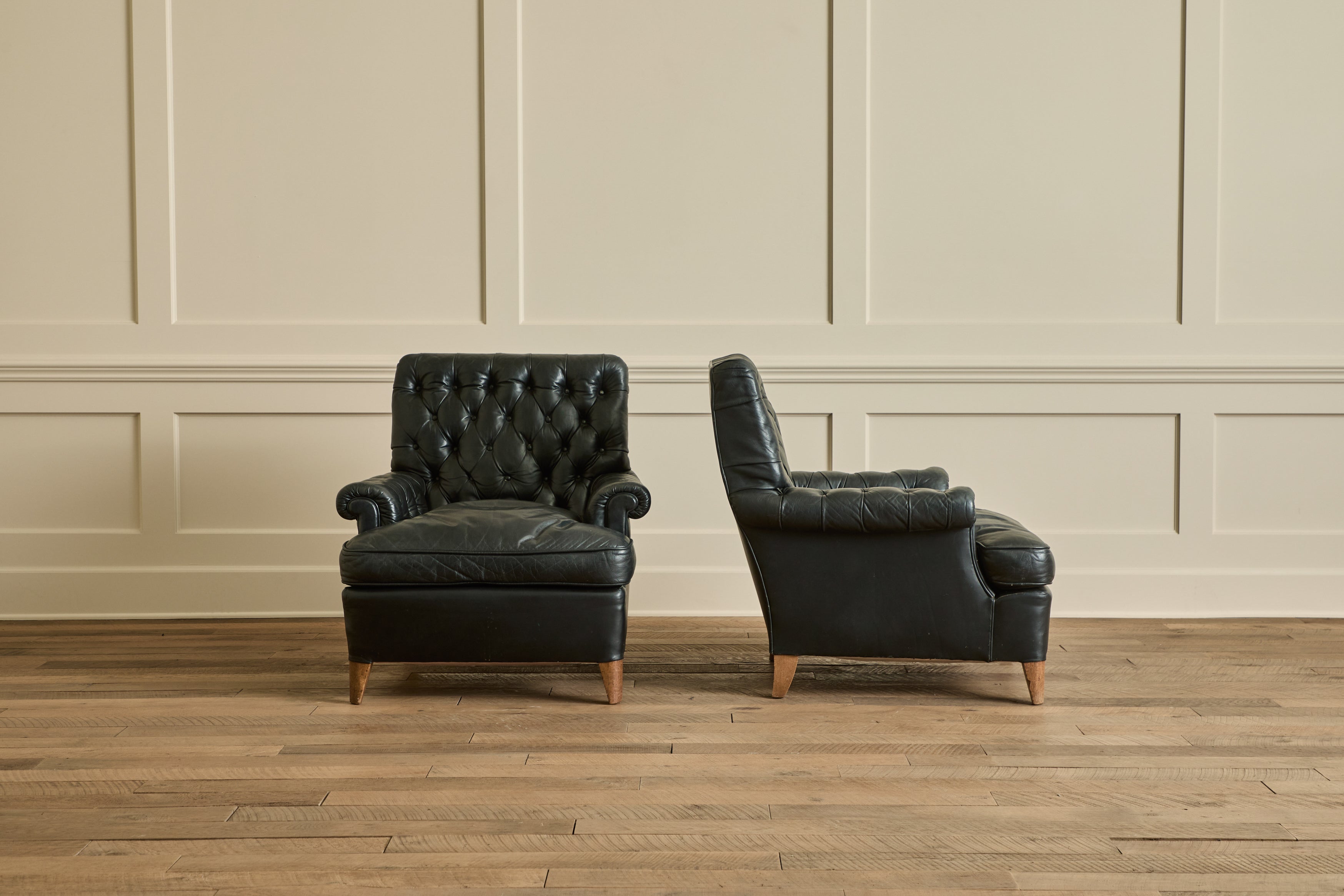 Pair of Tufted Black Leather Chairs