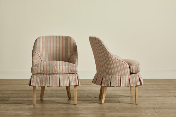 Two upholstered armchairs with striped fabric, one shown from the front and the other from the side, both with wooden legs.