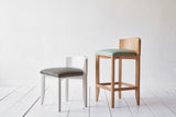 (L) NK Collection Vanity Stool Shown in Spruce Howe Maroc and Custom Finish; (R) NK Collection Counter Height Vanity Stool Shown in Howe Duck Egg Maroc and Natural Oak