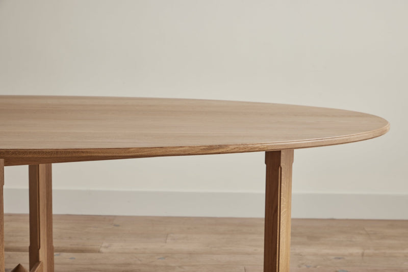 Full view of a rectangular wooden table with sturdy legs and a simple design.